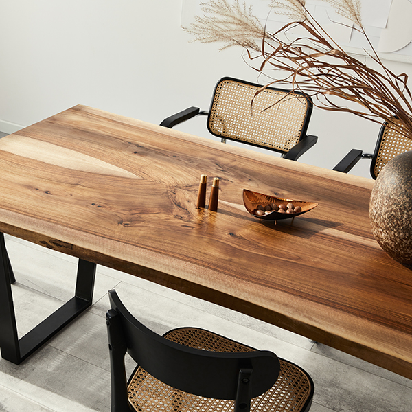 Stylish dining room wooden table with modern chairs