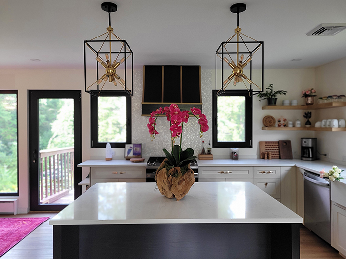 Modern kitchen with custom-built island, cabinets, hood range, and floating shelves by Jiri Parma.