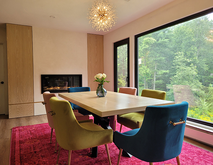 Dining area with custom built-ins gas fireplace and colorful chairs